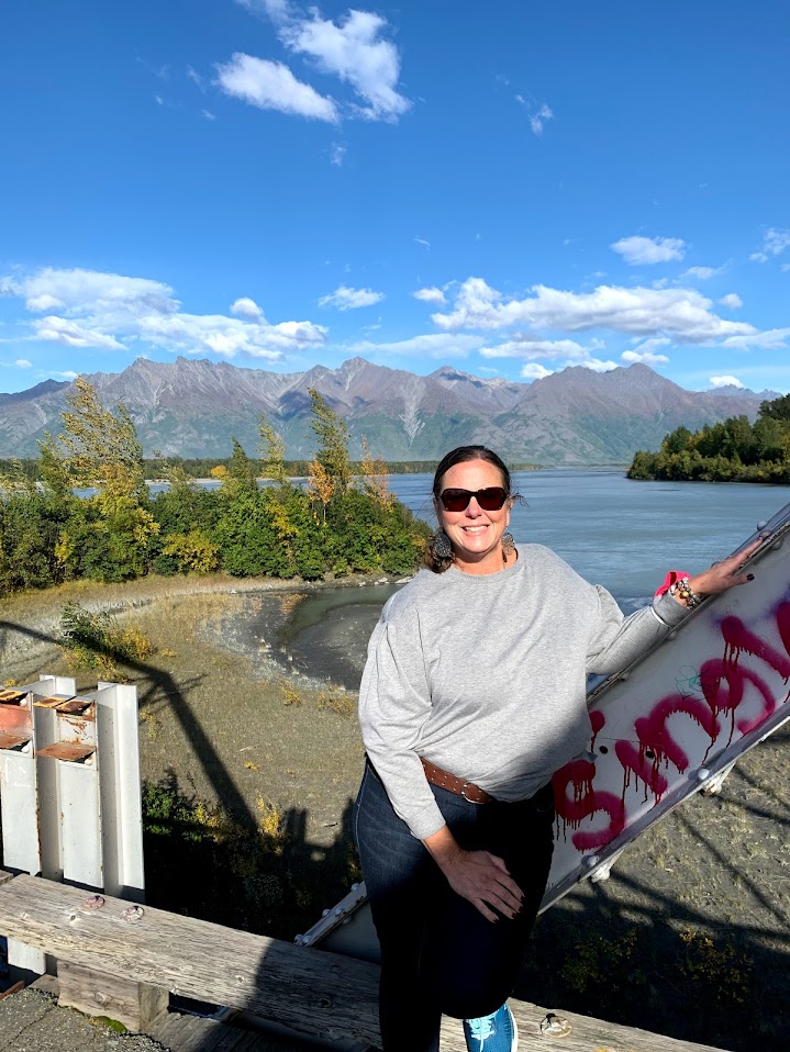 Cathy with river and mountain